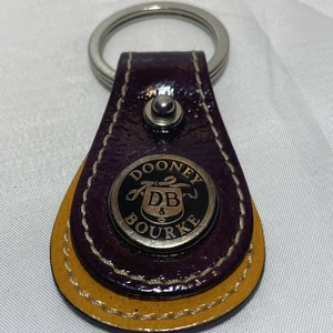 Llave DB de cuero para todo clima Dooney and Bourke de colección púrpura y amarillo - Imagen 1 de 6
