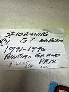 1991-96 Pontiac Grand Prix "GT" Emblem GM 10231016 NOS Black with Red - Picture 1 of 4