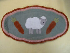 A Rustic Handmade Felt Doily With A Gray Faced Sheep and Carrots