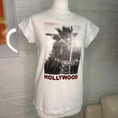 BNWT SOAKED IN LUXURY 100% COTTON WHITE RODEO DRIVE HOLLYWOOD T-SHIRT. SIZE XS - Image 1 of 4