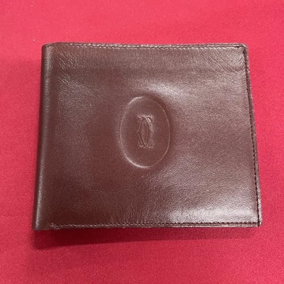 Cartera Burdeos Must De Cartier Paris Cuero Marrón y Rojo Plegable Doble Plegable Foto 1 de 4