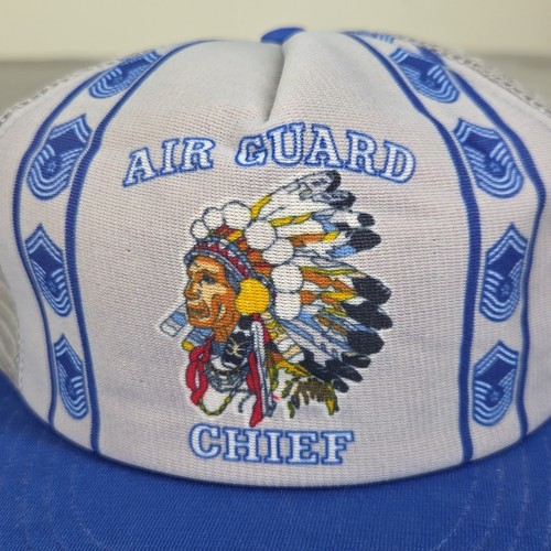 White 1980s US Air Force Indian Chief trucker hat with blue/white chevron logo and embroidered feathered headdress.