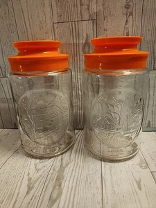 Juego de 2 tarros de vidrio vintage Anchor Hocking Bridge y cabina Tang tapa naranja - Imagen 1 de 4