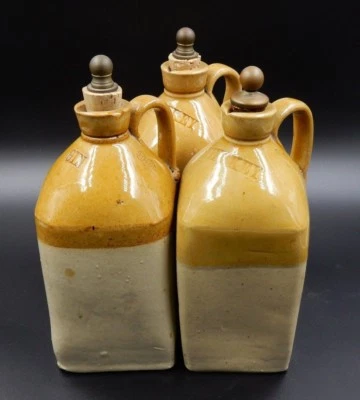 3 VINTAGE PORCELAIN BAR SPIRIT DECANTERS WITH BRASS AND CORK STOPPERS - Image 1 of 4
