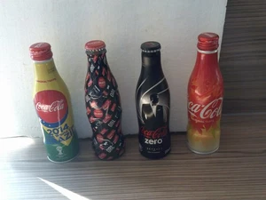four coca cola bottles all sealed, - Picture 1 of 1