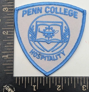 Penn College Hospitality Program Patch Shield Shape Blue on White Iron-On - Picture 1 of 2