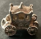 Lovely silver charm of opening carriage with people inside