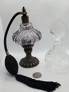 Set of 2 perfume bottles. 1 crystal w/ Etched flowers. 1 purple w/atomizer.  - Picture 1 of 5