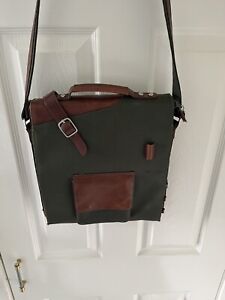 Mens green coated canvas messenger shoulder bag with leather trim.