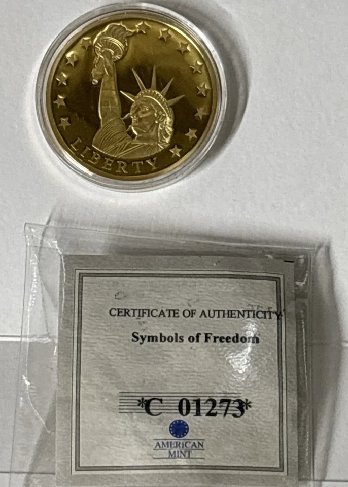 AMERICAN MINT SYMBOLS OF FREEDOM "STATUE OF LIBERTY / EAGLE"  GOLD PLATED COIN - Image 1 of 4