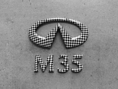 Infiniti M35 Black & White Houndstooth Rear Trunk Emblem Set x2 OEM Badges - Image 1 of 4