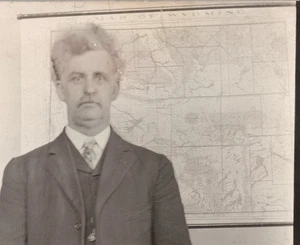 Wild-Haired, Crazy-Eyed Man in 3-piece Suit before Map of WYOMING RPPC 1904-1918 - Picture 1 of 3
