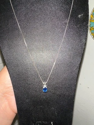 14kt white gold necklace with a small diamond next to a good-sized sapphire - Image 1 of 4