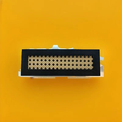 A contemporary decorative storage box featuring a woven rattan insert. - Image 1 of 3