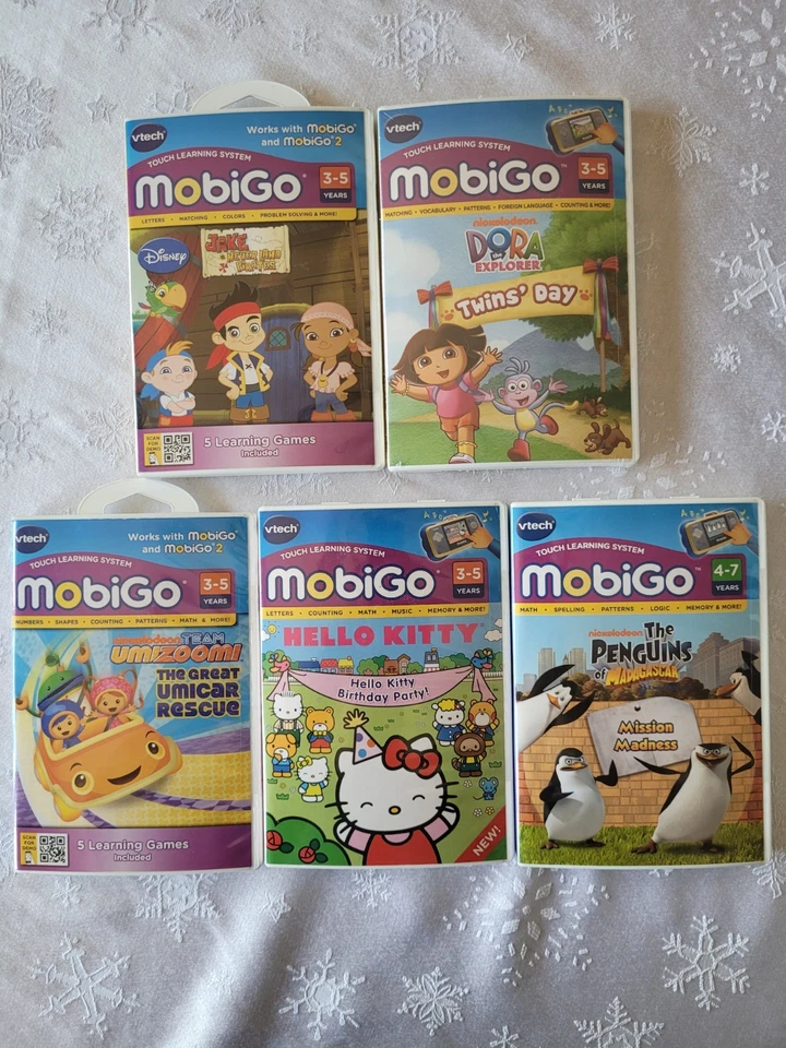V-tech Mobigo Games,Hello Kitty,Dora,Umizoomi,Penguins ,Jake and the Pirates - Image 1 of 4