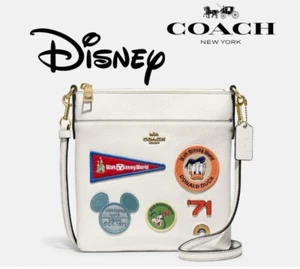 Disney X Coach Kitt C8573 Messenger Umhängetasche aus Messing/Kreide mit Patches - Bild 1 von 4