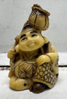collectible japanese netsuke detailed hand carved man carrying bag on stick