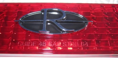 1964 Buick Riviera Tail Lamp Lens "R" Emblem. Die Cast Chrome Plated - Image 1 of 4