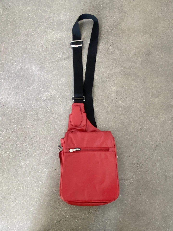 Travelon red leather cross body travel bag multiple pockets adjustable strap - Image 1 of 4