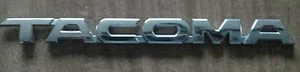 2005 - 2015 Toyota "TACOMA" Emblem OEM #75427-04010 - Picture 1 of 2