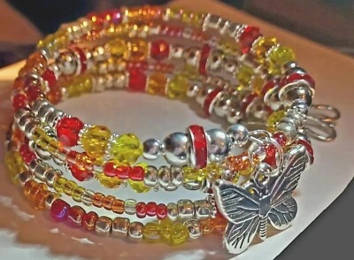 Pulsera de alambre de memoria con dijes de mariposa de plata cristal rojo, naranja, amarillo nueva sin etiquetas  Foto 1 de 4