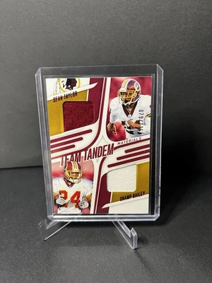 2025 Absolute Team Tandem Materials - Champ Bailey & Sean Taylor /115 - Image 1 of 2