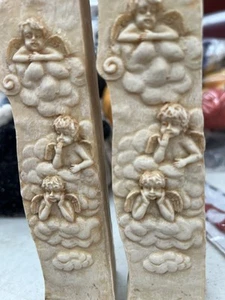 TWO CERAMIC TAPER CANDLE MULTI CHERUB CANDLESTICK HOLDERS BY INNOVATION 1997 - Picture 1 of 5