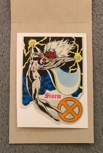 1994 MARVEL ENTERTAINMENT X-MEN VENDING MACHINE STORM ORANGE X STICKER CARD - Picture 1 of 2