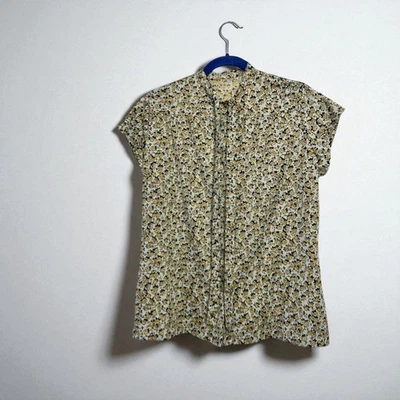 Blusa diaria vintage de poliéster floral de los años 70 con cuello atado Foto 1 de 4