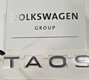 2GJ853687E 2ZZ BRAND NEW GENUINE VW  REAR HATCH CHROME EMBLEM   "TAOS"   2022-23 - Picture 1 of 2