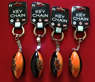 FOUR OKLAHOMA STATE COWBOYS PLASTIC, FOOTBALL KEY CHAINS FROM RICO INDUSTRIES - Image 1 of 2