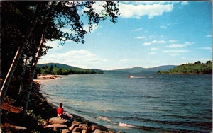 Relajándose en la orilla, barco pasando por postal NH Newfound Lake New Hampshire - Imagen 1 de 2