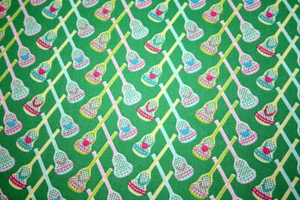 CROSSED LACROSSE STICKS ON GREEN - 100% COTTON FABRIC - Picture 1 of 3
