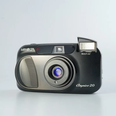 EXCELENTE MINOLTA Capios 20 Preto + Controle Remoto IR RC-3 Point & Shoot ... - Imagem 1 de 4