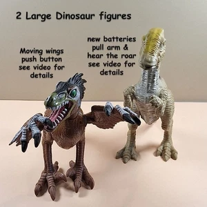 2 Dinosaur figures 1 with button to move wings 1 that roars push arm see video - Picture 1 of 3
