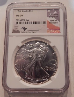 1987 SILVER EAGLE NGC MS70 JOHN MERCANTI HAND SIGNED FLAG LABEL - Image 1 of 2