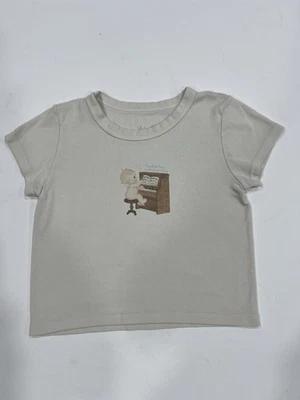 Brandy Melville John Galt Cream Cropped Baby Tee With Baby Playing Piano Graphic - Image 1 of 3
