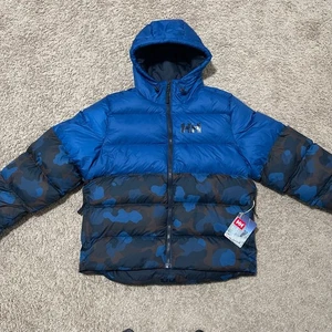 Chaqueta acolchada Helly Hansen para hombre grande azul camuflada activa hinchada aislada con capucha - Imagen 1 de 15