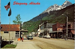Vintage AK Postcard Skagway Broadway Street View Old Cars Flag - Picture 1 of 4