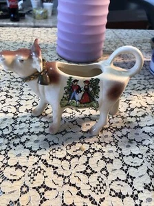 Vintage Porcelain cow Figurine with bell made in Switzerland 5 inches long - Picture 1 of 7