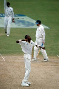 West Indies fast bowler Curtly Ambrose celebrates after dismi- Old Cricket Photo - Picture 1 of 1