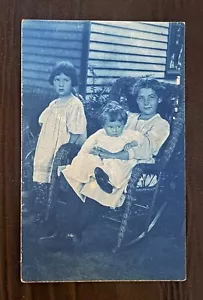 CYANOTYPE BLUE REAL PHOTO POSTCARD RPPC~THREE CHILDREN & WICKER ROCKING CHAIR - Picture 1 of 2