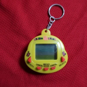 Dinkie Dino, Tamagotchi gelb, Virtual Pet 90er, Digital Pet, 26in1 Pocket Pet - Bild 1 von 5