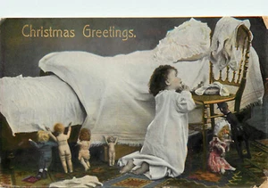 Merry Christmas Postcard Little Girl Lines Up Her Dolls For Prayers 1112/1 - Picture 1 of 2