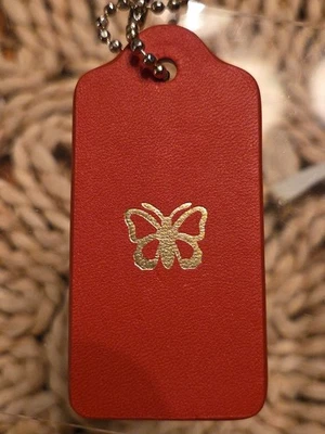 Llavero Coach Cuero Naranja con Mariposa Etiqueta Colgante Bolso Dije Llavero Llavero 🧡 Foto 1 de 4