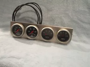 Auto Meter Water (3431), Oil (3421), Volts, and Amps Gauges Mounted in Holder - Picture 1 of 2