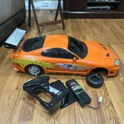 ORANGE 1995 TOYOTA SUPRA JADA TOYS RC CAR  REMOTE  SELLING AS PARTS & REPAIRS  - Image 1 of 4