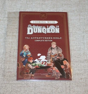 ANIME EXPO 2025 COOKING WITH DELICIOUS DUNGEON THE ADVENTURES BIBLE - Picture 1 of 1