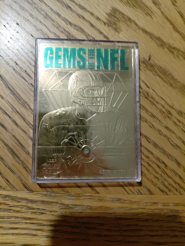 DAN MARINO GEMS OF THE NFL. 23 KT GOLD WITH A SMALL EMERALD  - Image 1 of 4