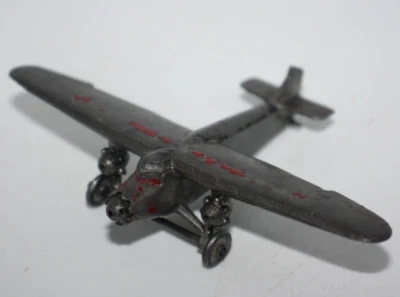 Vtg C.A.W. #12 Ford Tri-Motor Model 4 Slush Metal Toy Airplane missing propeller - Image 1 of 4
